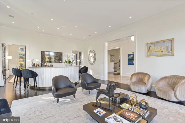 a view of a dining room with furniture a chandelier and wooden floor