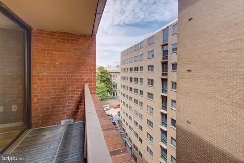 a view of a balcony with wooden floor and windows