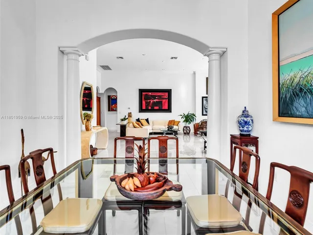 a kitchen with stainless steel appliances kitchen island granite countertop a sink and a white cabinets