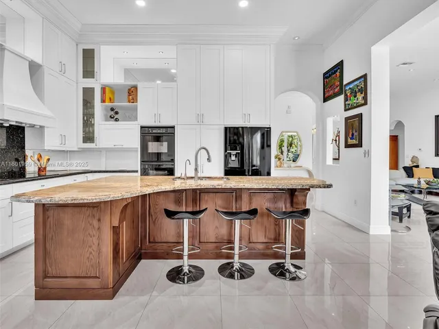 a kitchen with stainless steel appliances a stove a sink and a refrigerator