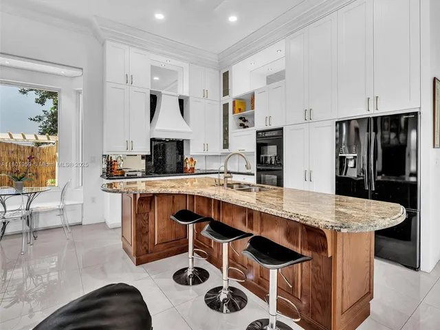 a kitchen with sink refrigerator and window