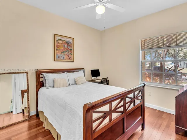 a bedroom with a bed and a tv