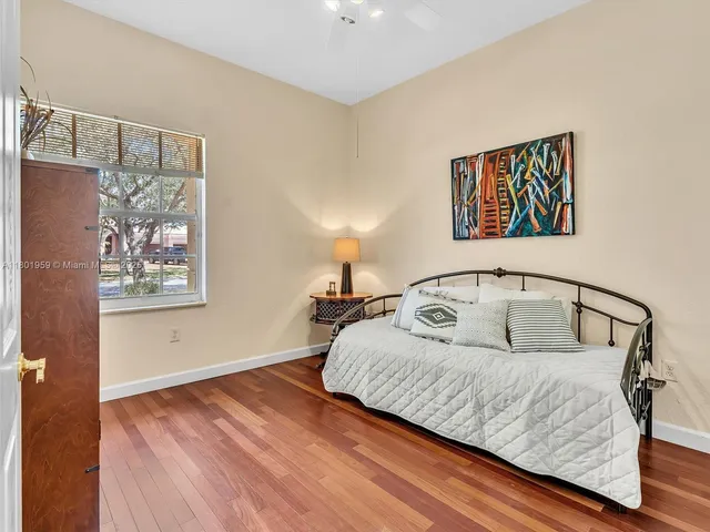 a view of a bedroom with wooden floor