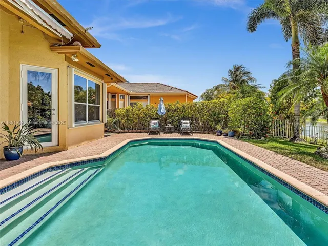 a view of a house with a swimming pool and a porch
