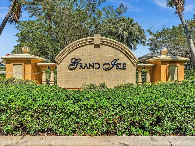 a park with water view and palm trees