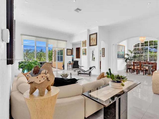 a living room with furniture and large windows