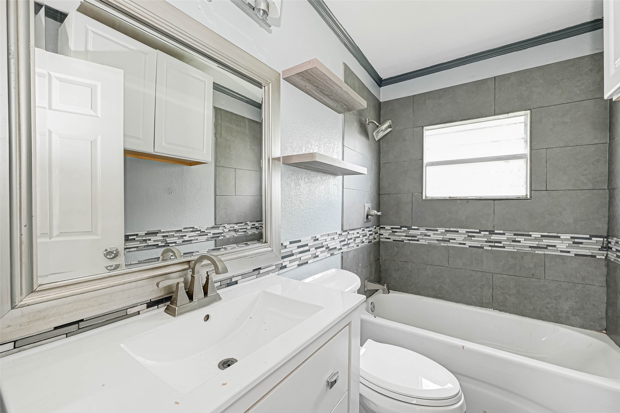 4821 Alvin Street Houston, TX 77033 - Photo 12 of 15 a bathroom with a sink a toilet and bathtub