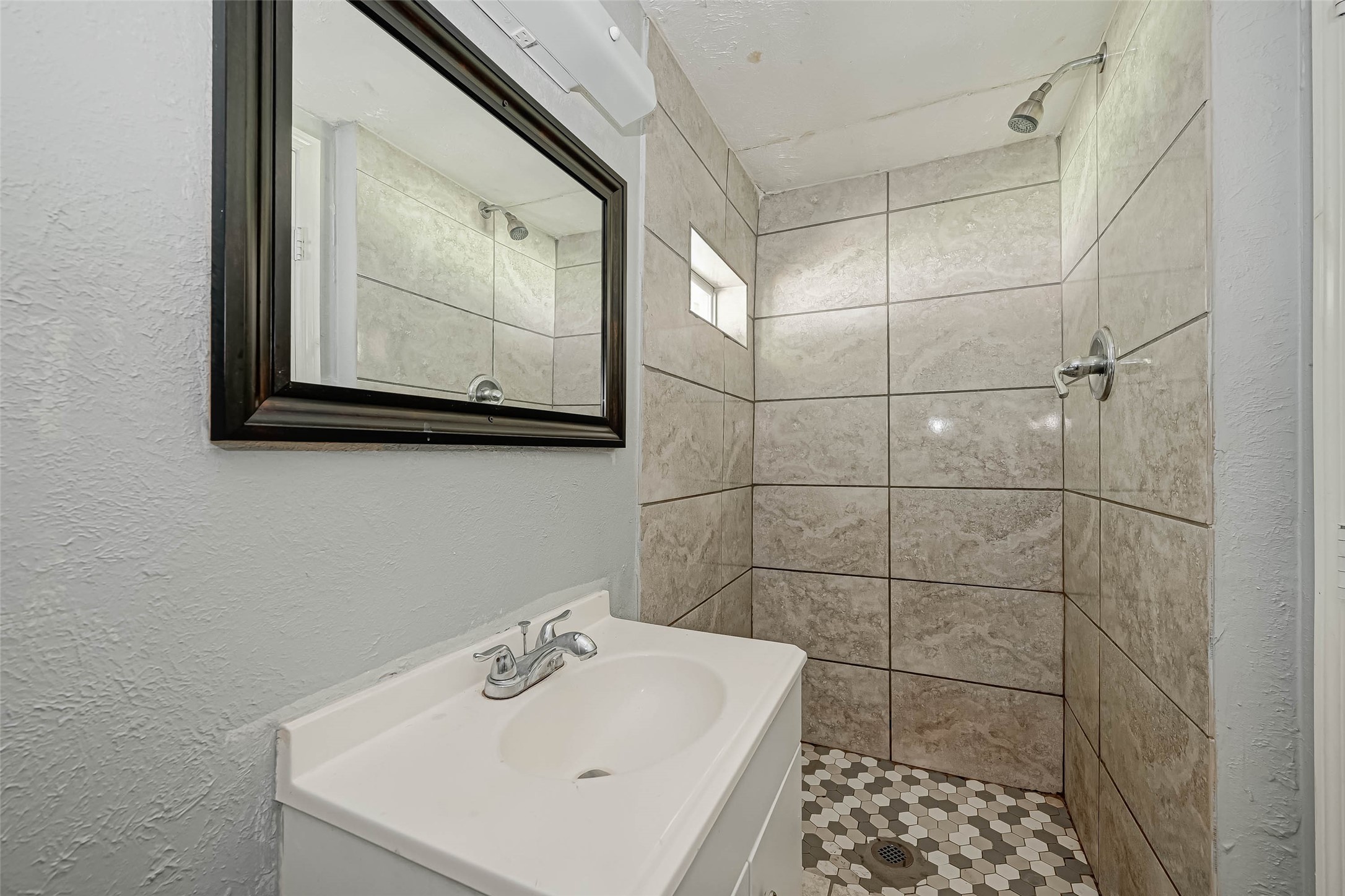 4821 Alvin Street Houston, TX 77033 - Photo 8 of 15 a bathroom with a sink a mirror and vanity