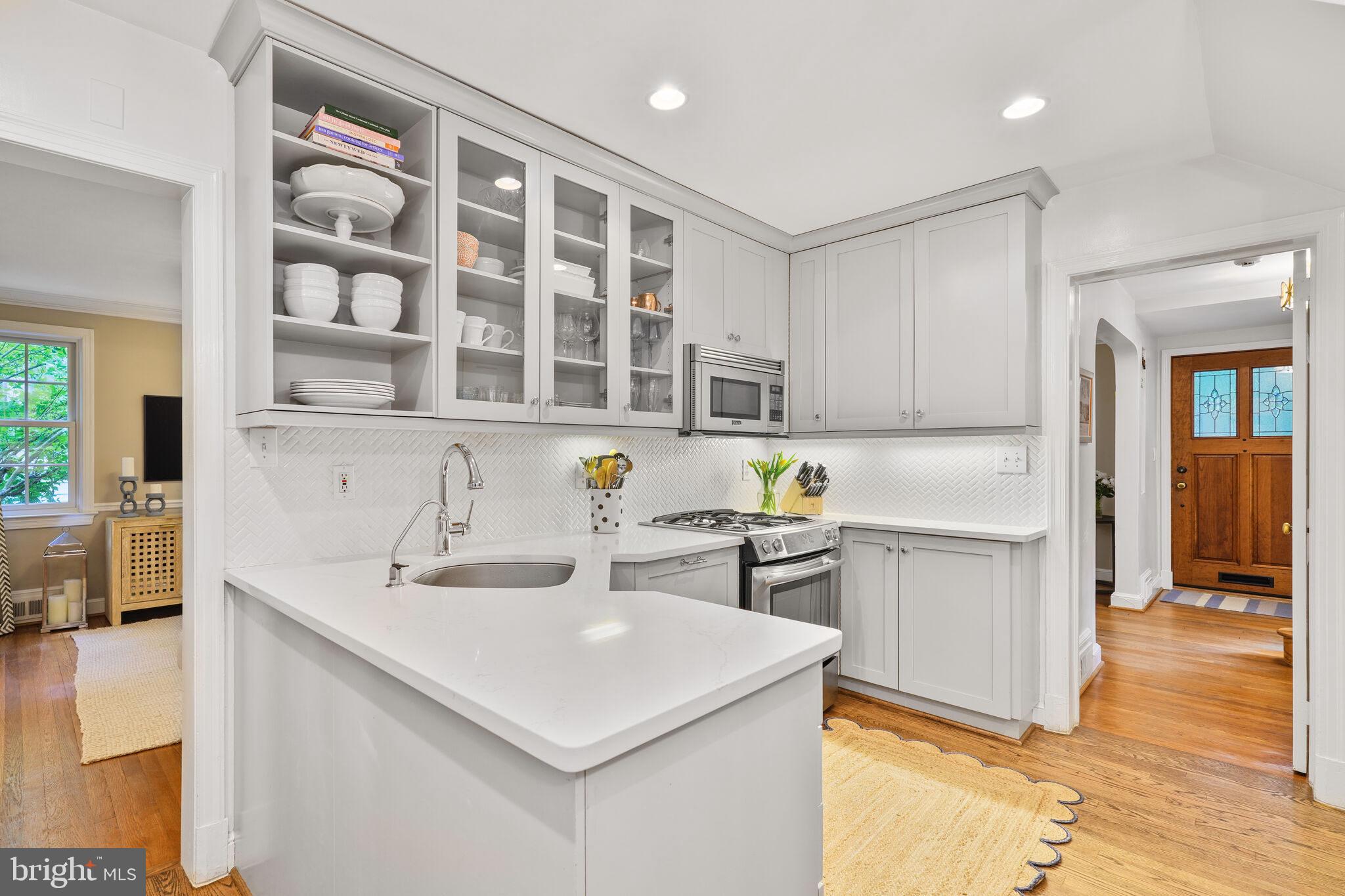 5442 Broad Branch Road Northwest Washington, DC 20015 - Photo 11 of 28 a kitchen with a sink a stove and cabinets