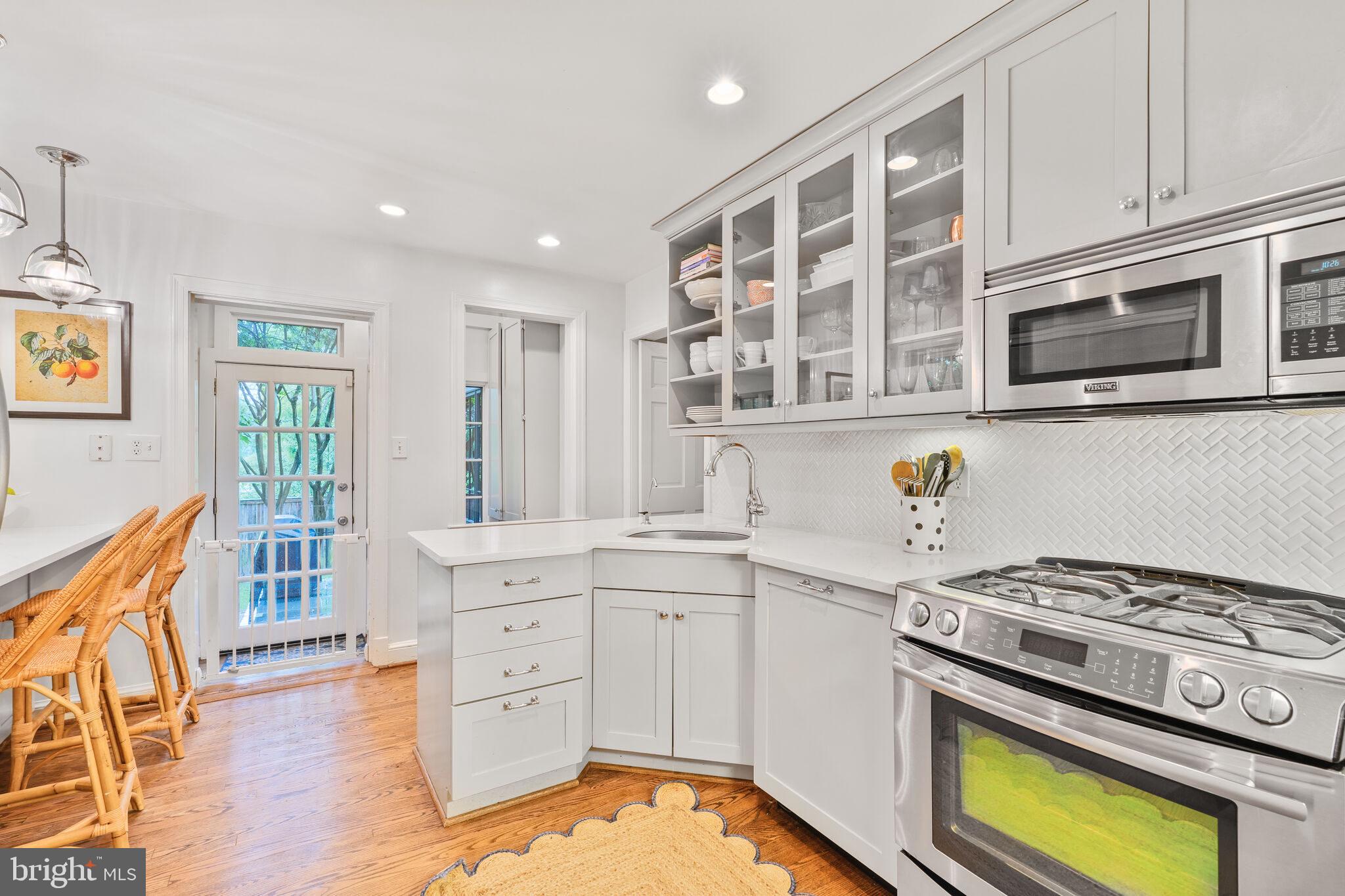 5442 Broad Branch Road Northwest Washington, DC 20015 - Photo 13 of 28 a kitchen with stainless steel appliances granite countertop a stove and a sink