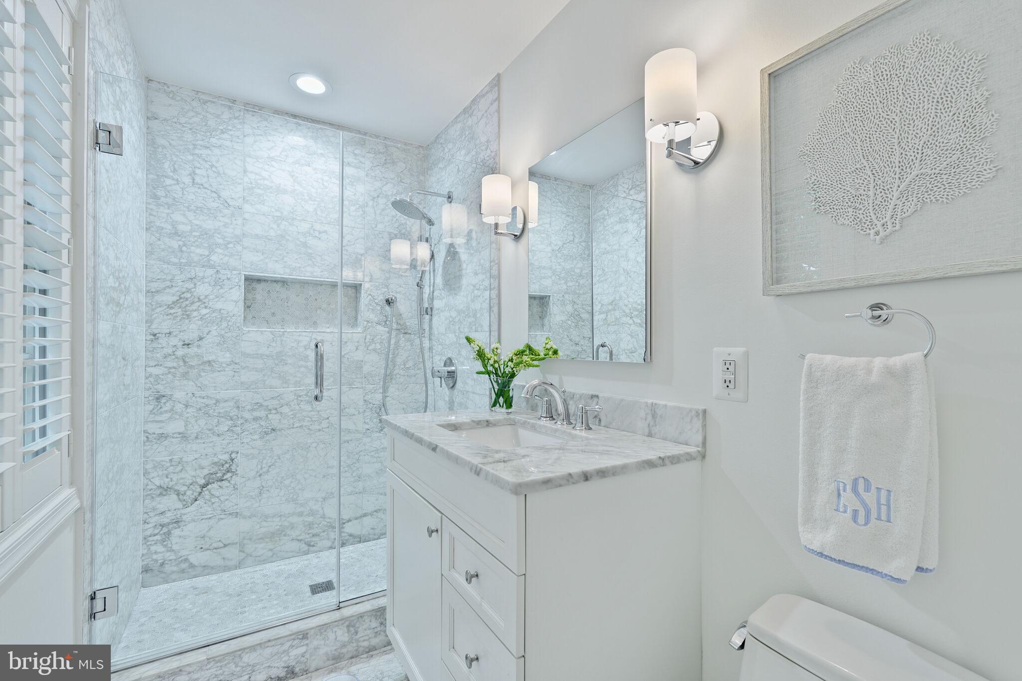 5442 Broad Branch Road Northwest Washington, DC 20015 - Photo 15 of 28 a bathroom with a granite countertop sink a mirror and a shower