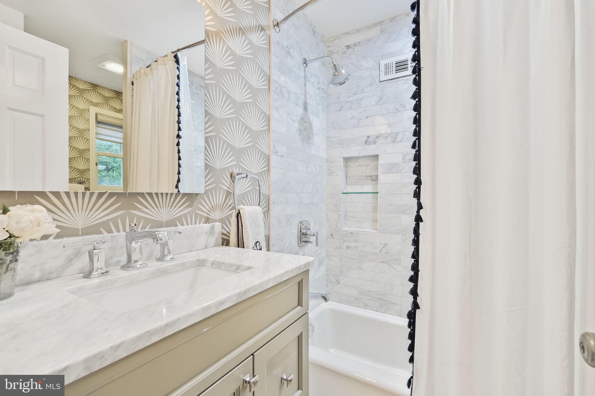 5442 Broad Branch Road Northwest Washington, DC 20015 - Photo 17 of 28 a bathroom with a granite countertop sink a mirror and a shower