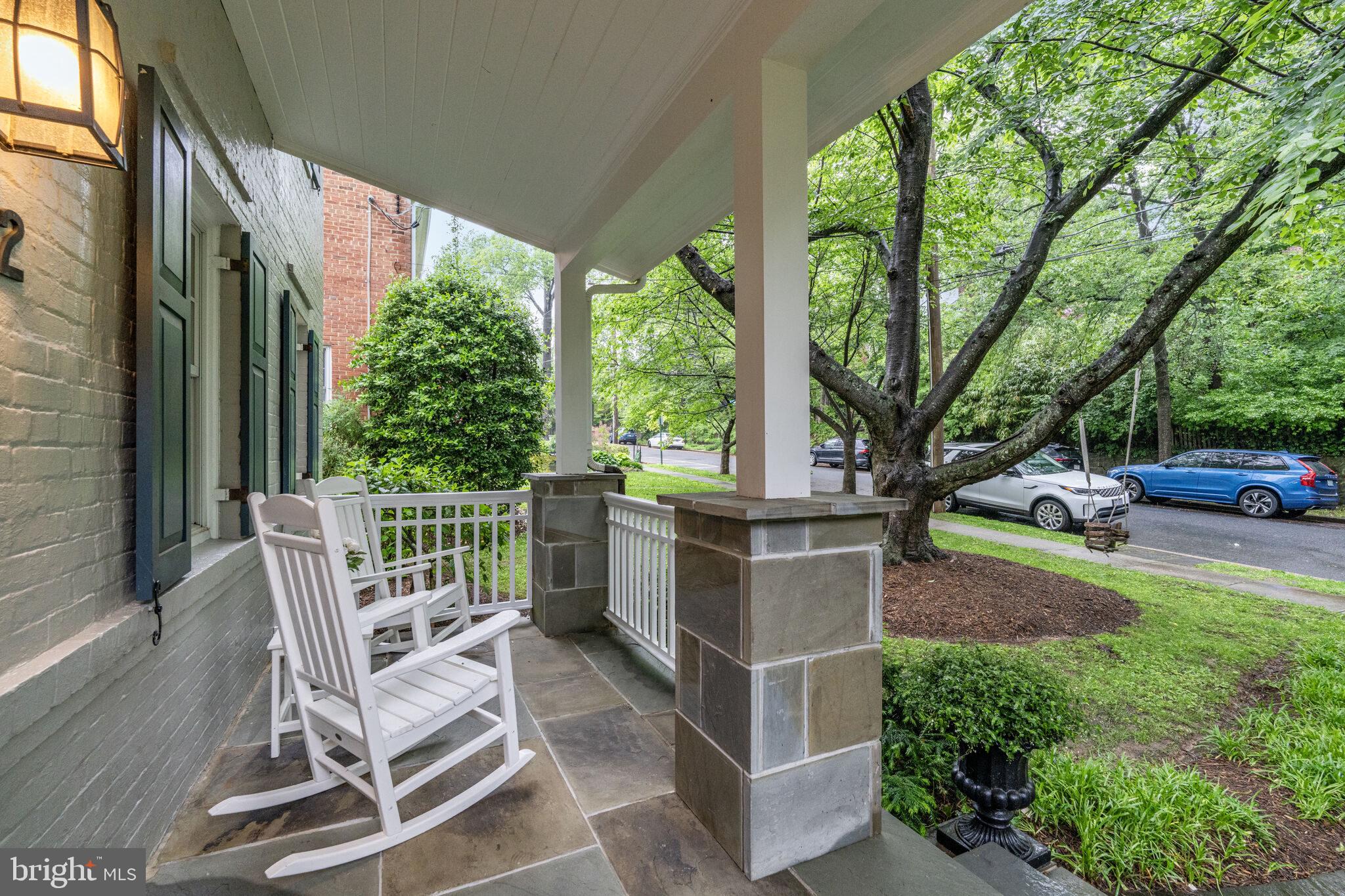 5442 Broad Branch Road Northwest Washington, DC 20015 - Photo 2 of 28 a view of a patio with a table chairs and a floor to ceiling window with garden