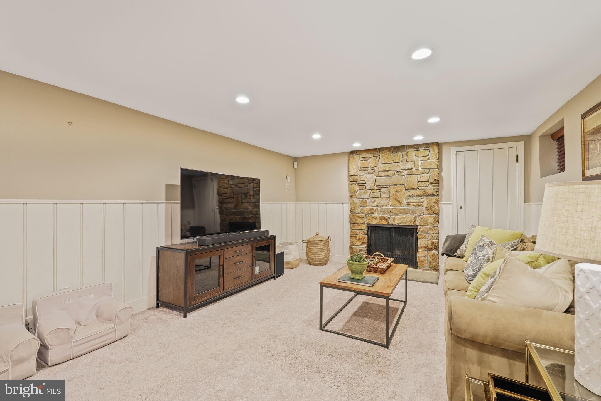 5442 Broad Branch Road Northwest Washington, DC 20015 - Photo 22 of 28 a living room with furniture and a flat screen tv