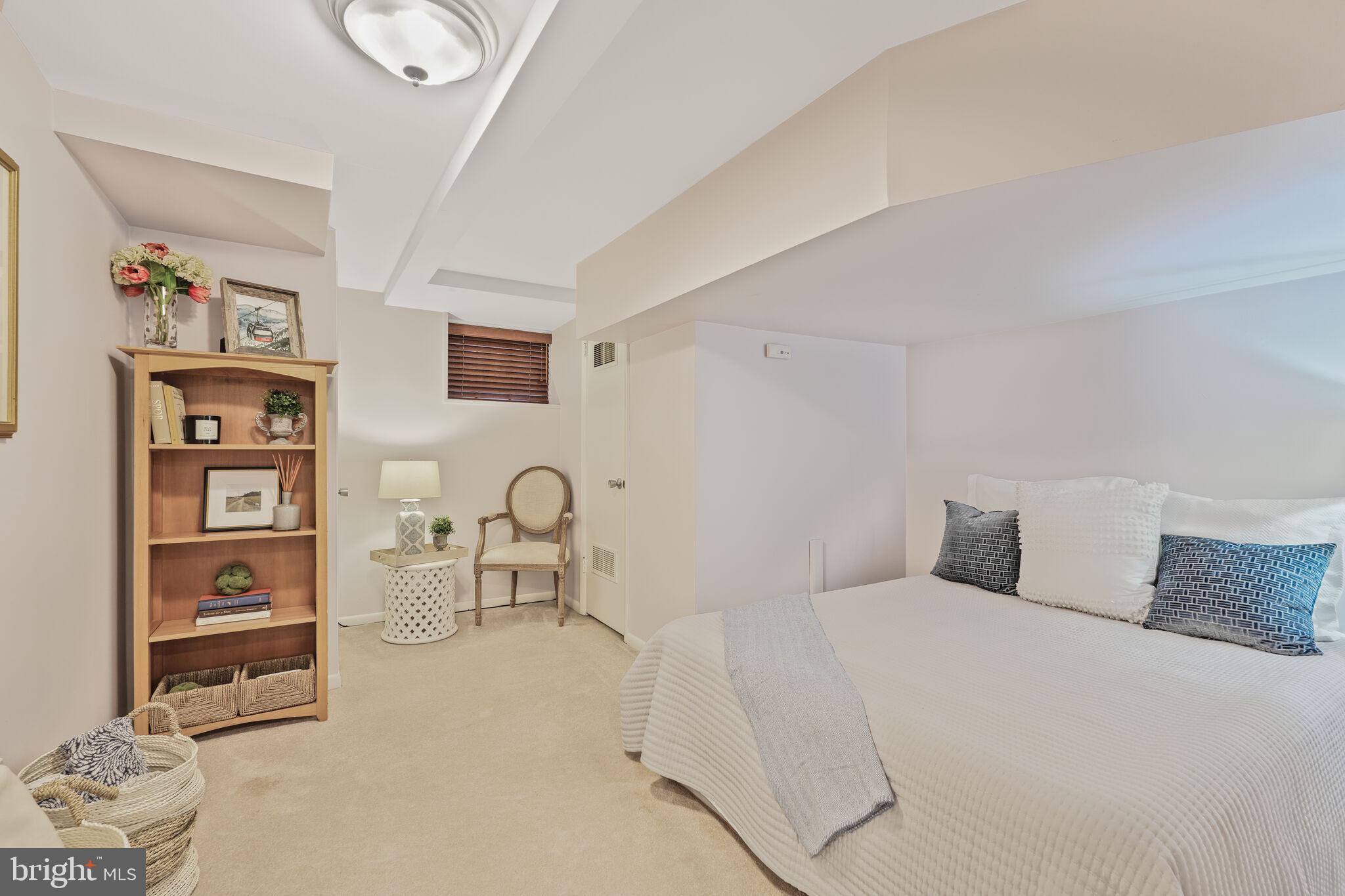 5442 Broad Branch Road Northwest Washington, DC 20015 - Photo 24 of 28 a bedroom with a bed and book shelf