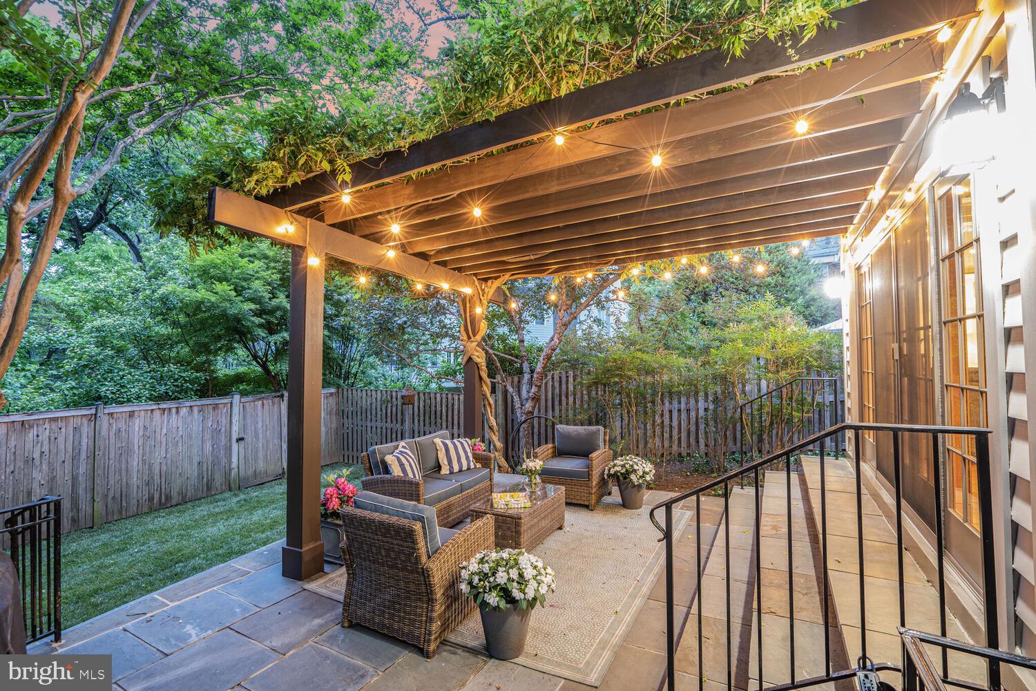 5442 Broad Branch Road Northwest Washington, DC 20015 - Photo 27 of 28 a view of a patio with a table chairs and a backyard
