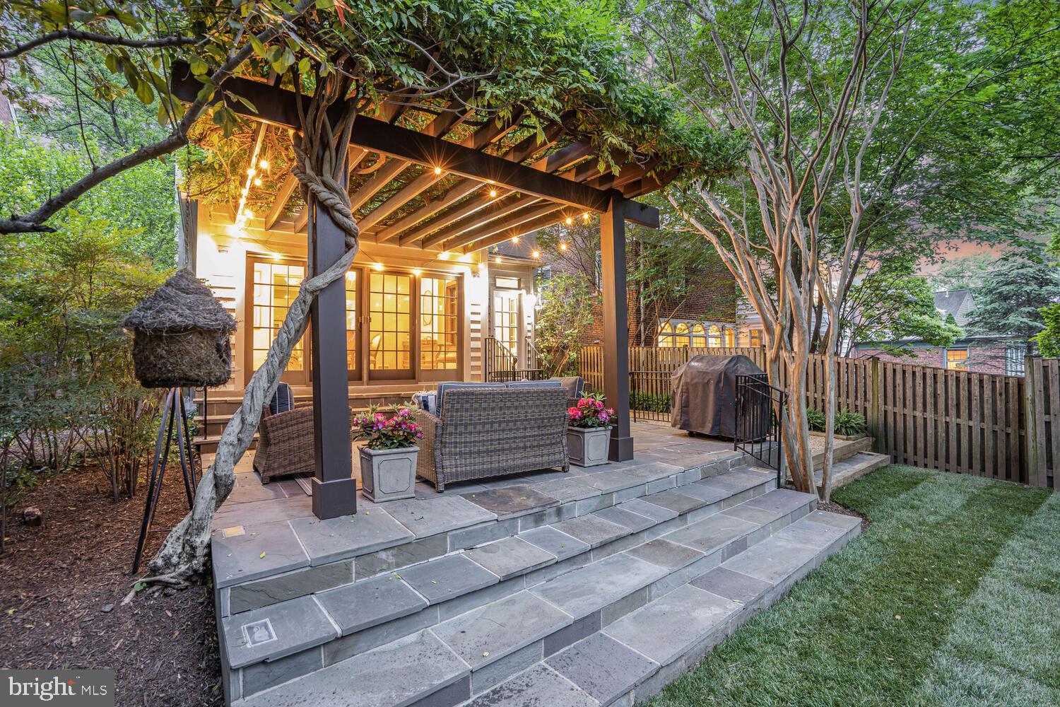 5442 Broad Branch Road Northwest Washington, DC 20015 - Photo 28 of 28 a backyard of a house with barbeque oven table and chairs