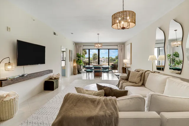 a dining room with furniture and a floor to ceiling window