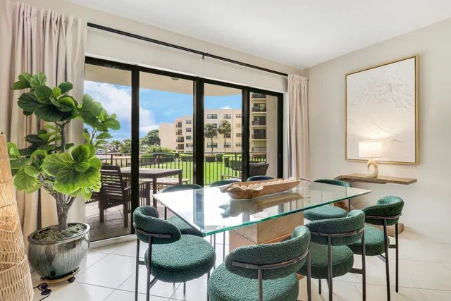a living room with furniture a chandelier and a flat screen tv