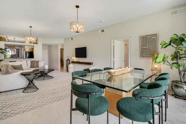 a dining room with furniture and a floor to ceiling window