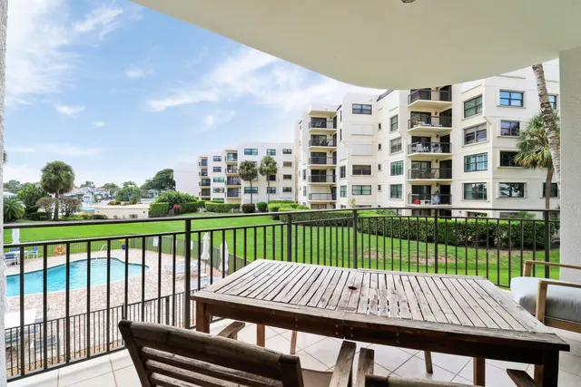 a view of a balcony with lake view and wooden floor