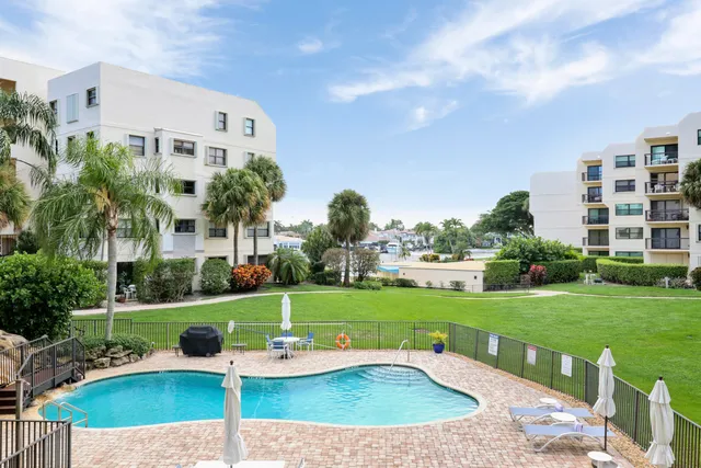 a spacious bedroom with a bed and glass window