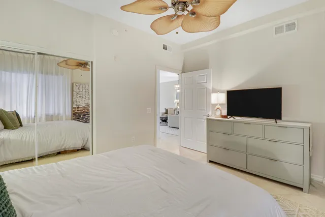a bathroom with a granite countertop sink toilet and a mirror