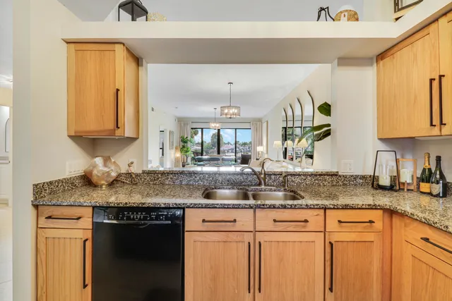 a kitchen with stainless steel appliances granite countertop a stove and a sink