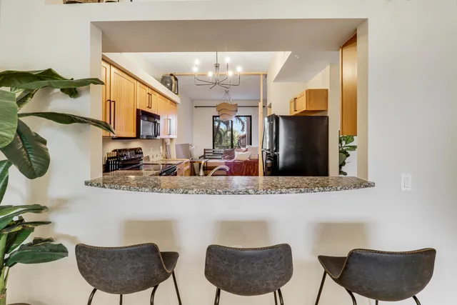 a living room with fireplace furniture and a potted plant