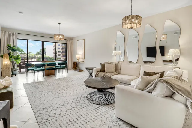 a living room with furniture a rug and white walls
