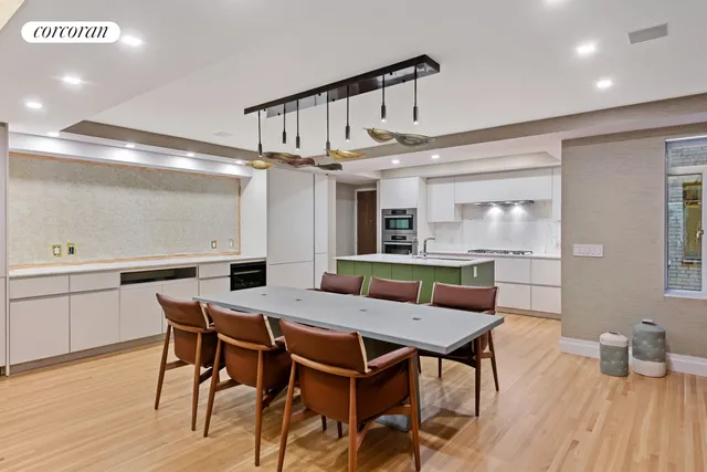 a kitchen with kitchen island stainless steel appliances a sink and cabinets