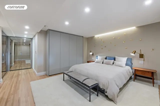 a spacious bedroom with a bed and a table in it