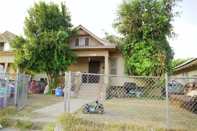 a view of a house with a tree in the background