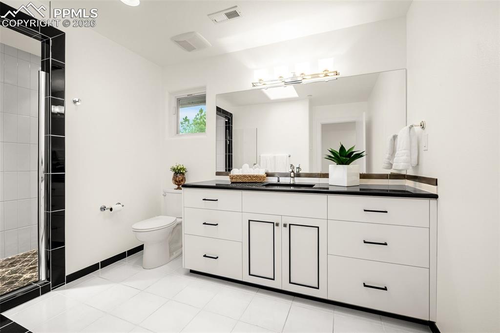 205 Cobblestone Way Monument, CO 80132 - Photo 26 of 45 a bathroom with a toilet sink and mirror