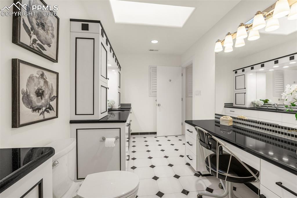 205 Cobblestone Way Monument, CO 80132 - Photo 27 of 45 a bathroom with a sink a toilet a mirror and shower