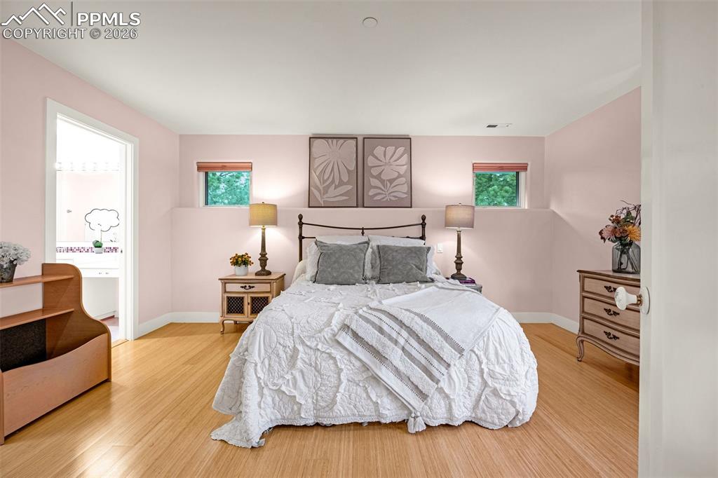 205 Cobblestone Way Monument, CO 80132 - Photo 30 of 45 a bedroom with a bed and wooden floor