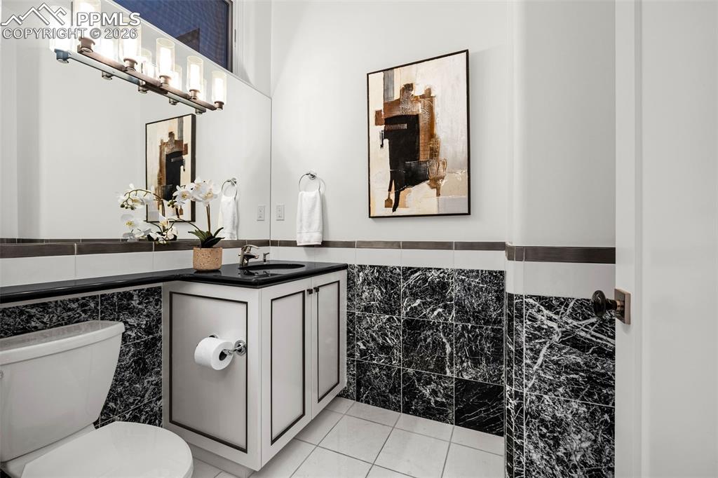 205 Cobblestone Way Monument, CO 80132 - Photo 31 of 45 a bathroom with a sink a toilet and mirror