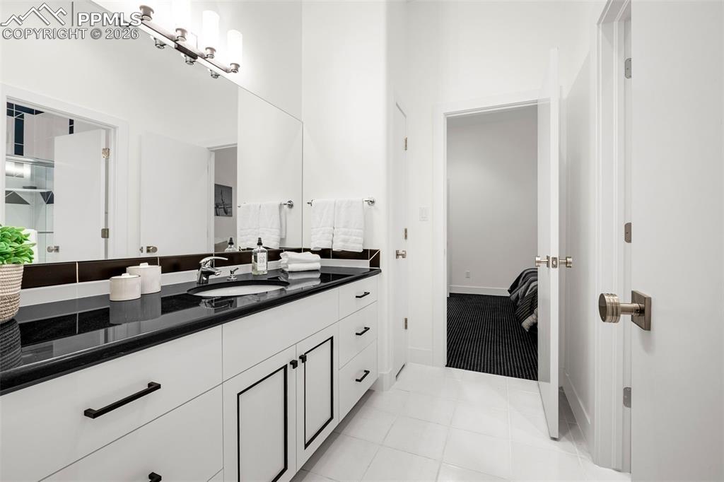 205 Cobblestone Way Monument, CO 80132 - Photo 35 of 45 a bathroom with a sink and a mirror