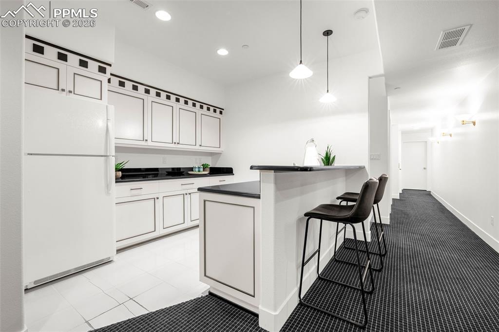 205 Cobblestone Way Monument, CO 80132 - Photo 37 of 45 a kitchen with granite countertop white cabinets and white appliances