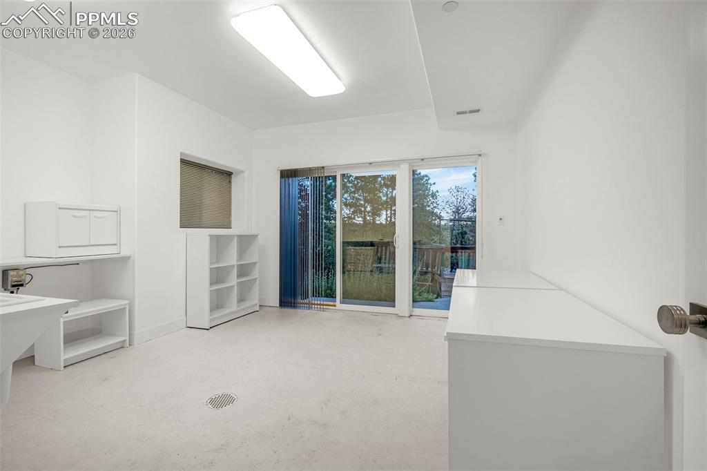 205 Cobblestone Way Monument, CO 80132 - Photo 38 of 45 a view of an empty room with a fireplace and a window