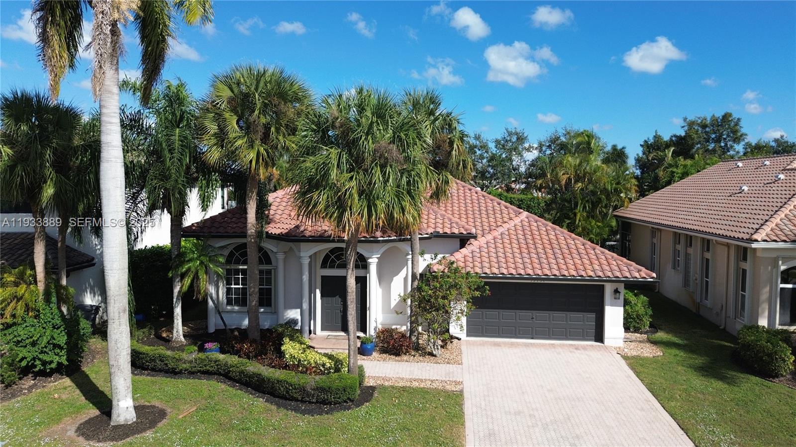 19754 Dinner Key Drive Boca Raton, FL 33498 - Photo 1 of 48 a front view of a house with garden