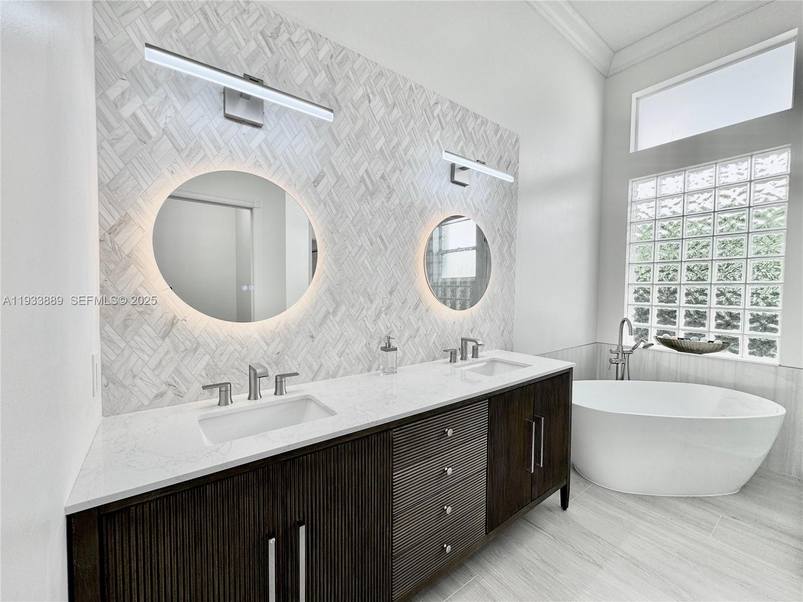 19754 Dinner Key Drive Boca Raton, FL 33498 - Photo 17 of 48 a bathroom with a double vanity sink double mirror and bathtub