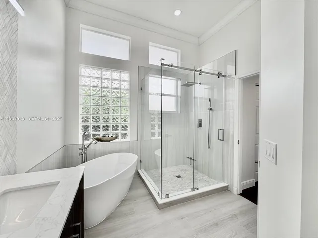 a bedroom with bed and a chandelier