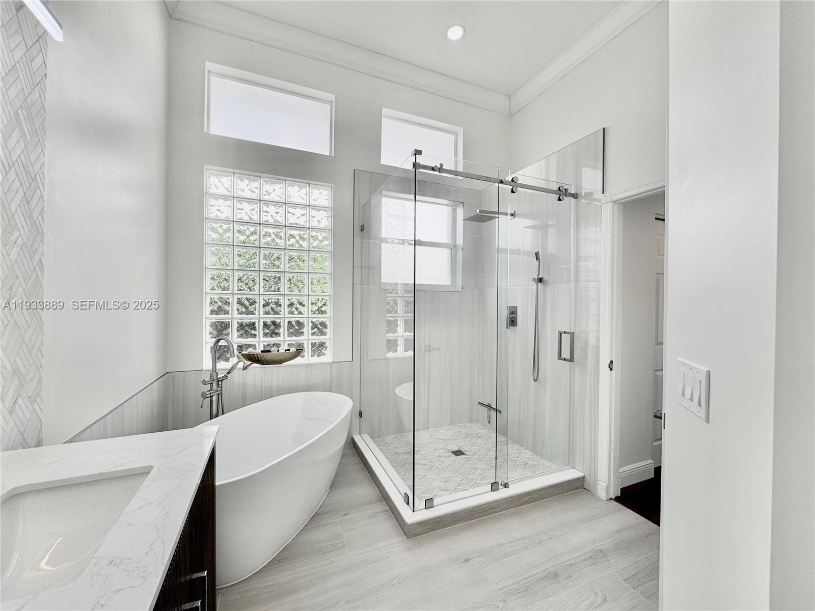 19754 Dinner Key Drive Boca Raton, FL 33498 - Photo 18 of 48 a bathroom with a tub shower and window