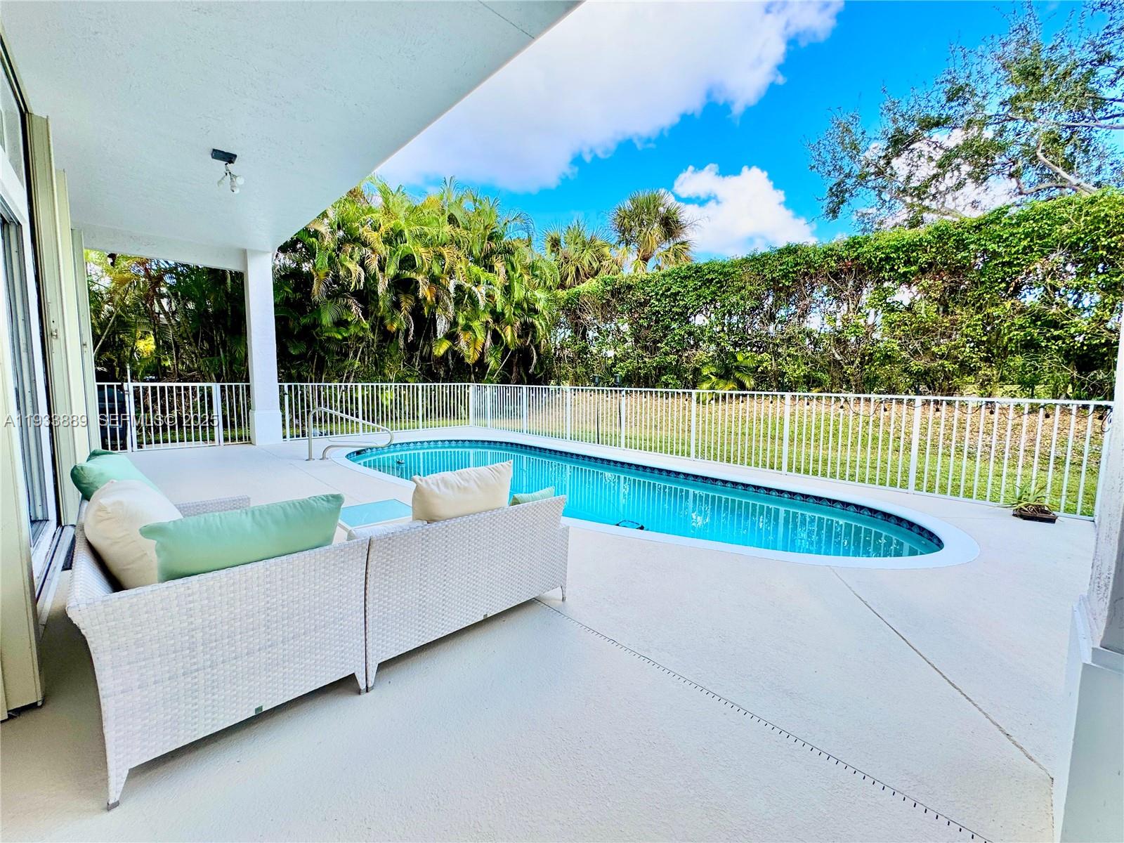 19754 Dinner Key Drive Boca Raton, FL 33498 - Photo 25 of 48 a view of a swimming pool with a lounge chair
