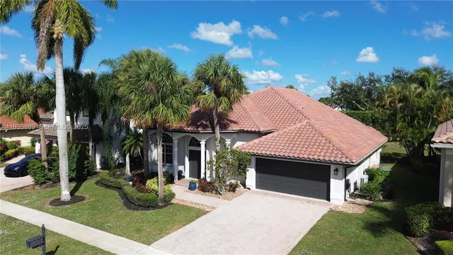 an aerial view of residential houses with outdoor space and parking
