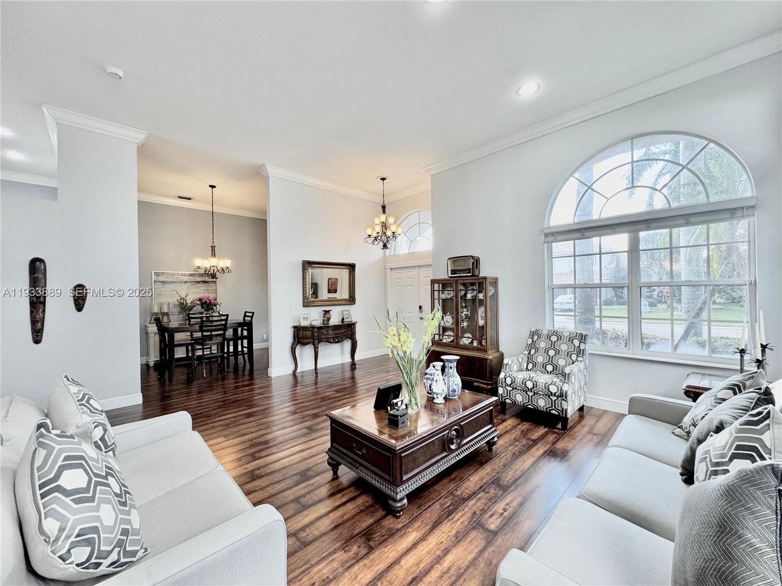 19754 Dinner Key Drive Boca Raton, FL 33498 - Photo 3 of 48 a living room with furniture large window and wooden floor