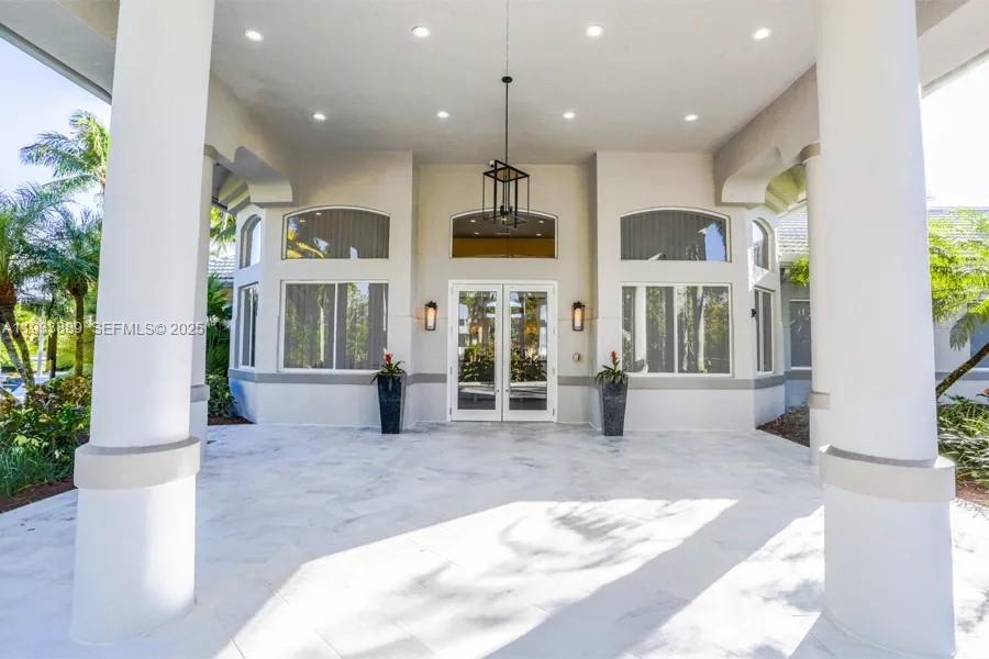 19754 Dinner Key Drive Boca Raton, FL 33498 - Photo 34 of 48 a view of a room with lots of windows and couches