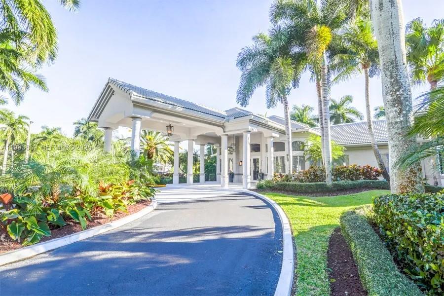 19754 Dinner Key Drive Boca Raton, FL 33498 - Photo 35 of 48 a front view of a house with swimming pool having outdoor seating