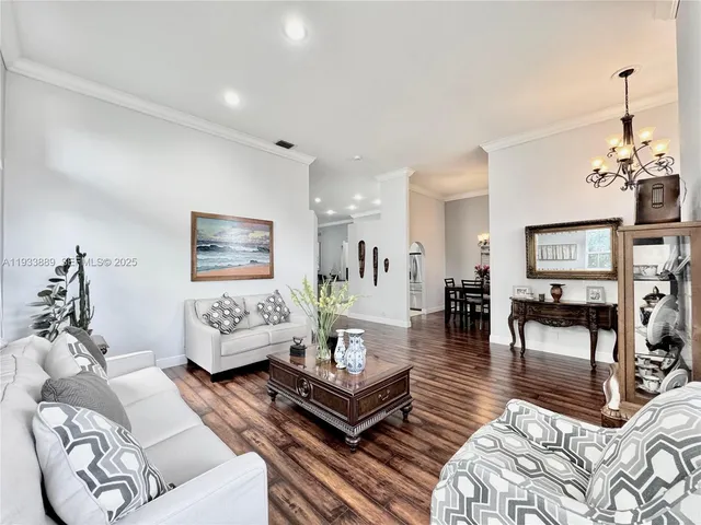 a living room with furniture and a dining table
